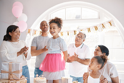 Buy stock photo Shot of a little girl enjoying a birthday party with her family at home