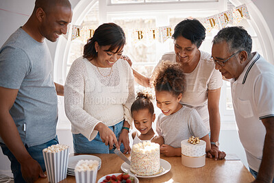 Buy stock photo Shot of a family cutting a cake and  celebrating a birthday party at home