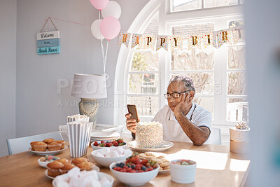 Buy stock photo Shot of a senior man looking unhappy while celebrating his birthday alone at home