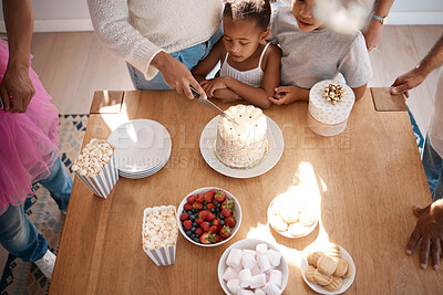 Buy stock photo Shot of a family preparing to eat a cake at a birthday party at home