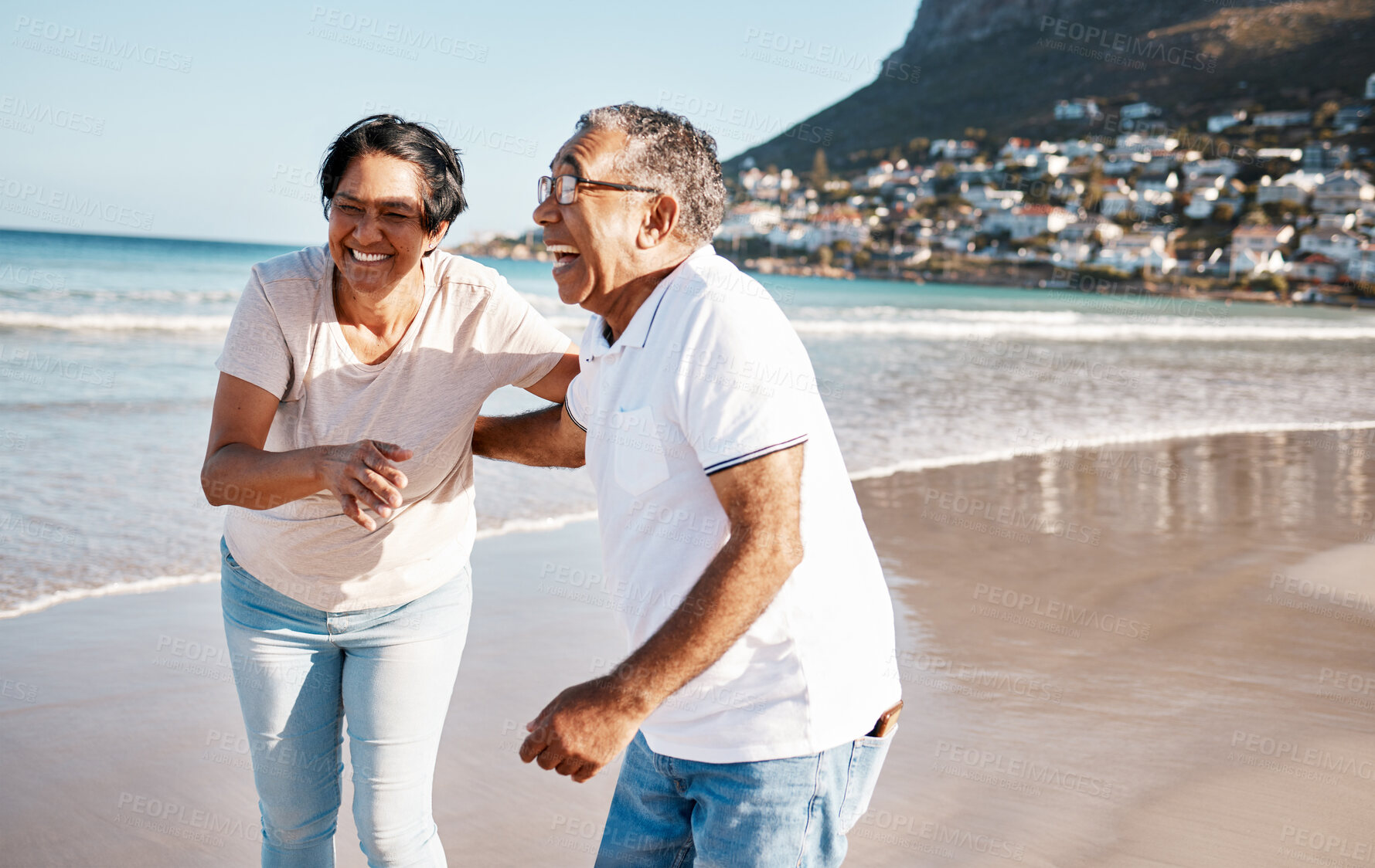 Buy stock photo Outdoor, laughing and senior couple at beach for happiness, funny joke or summer getaway trip. Ocean, married woman and elderly man walking on coast for love, adventure or holiday vacation in Bahamas