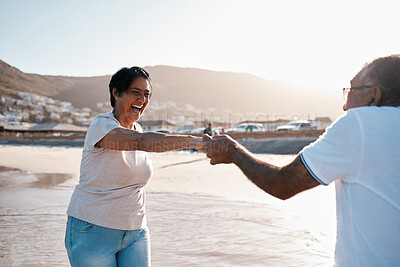 Buy stock photo Shot of a mature couple spending time at the beach