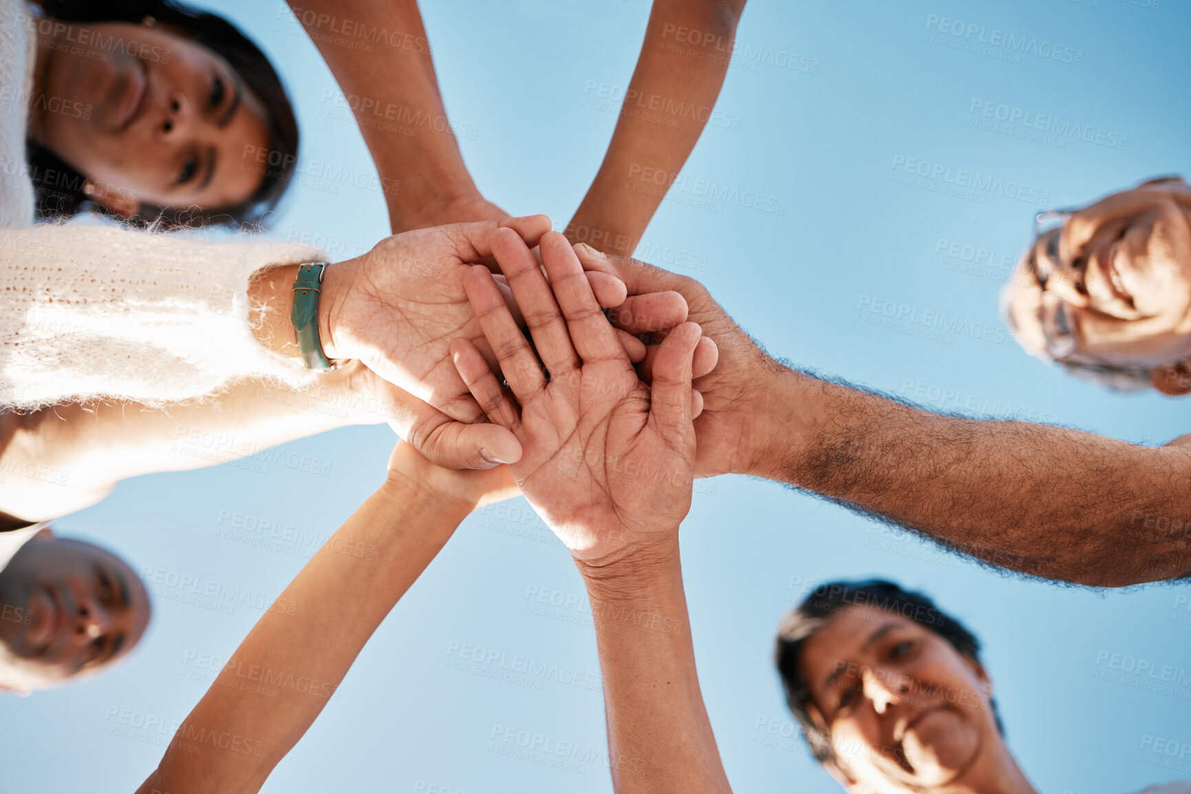 Buy stock photo Sky, hands and people together in circle with smile, connection and solidarity on outdoor vacation. Big family, men and women in huddle with love, support and bonding on holiday travel in Mexico