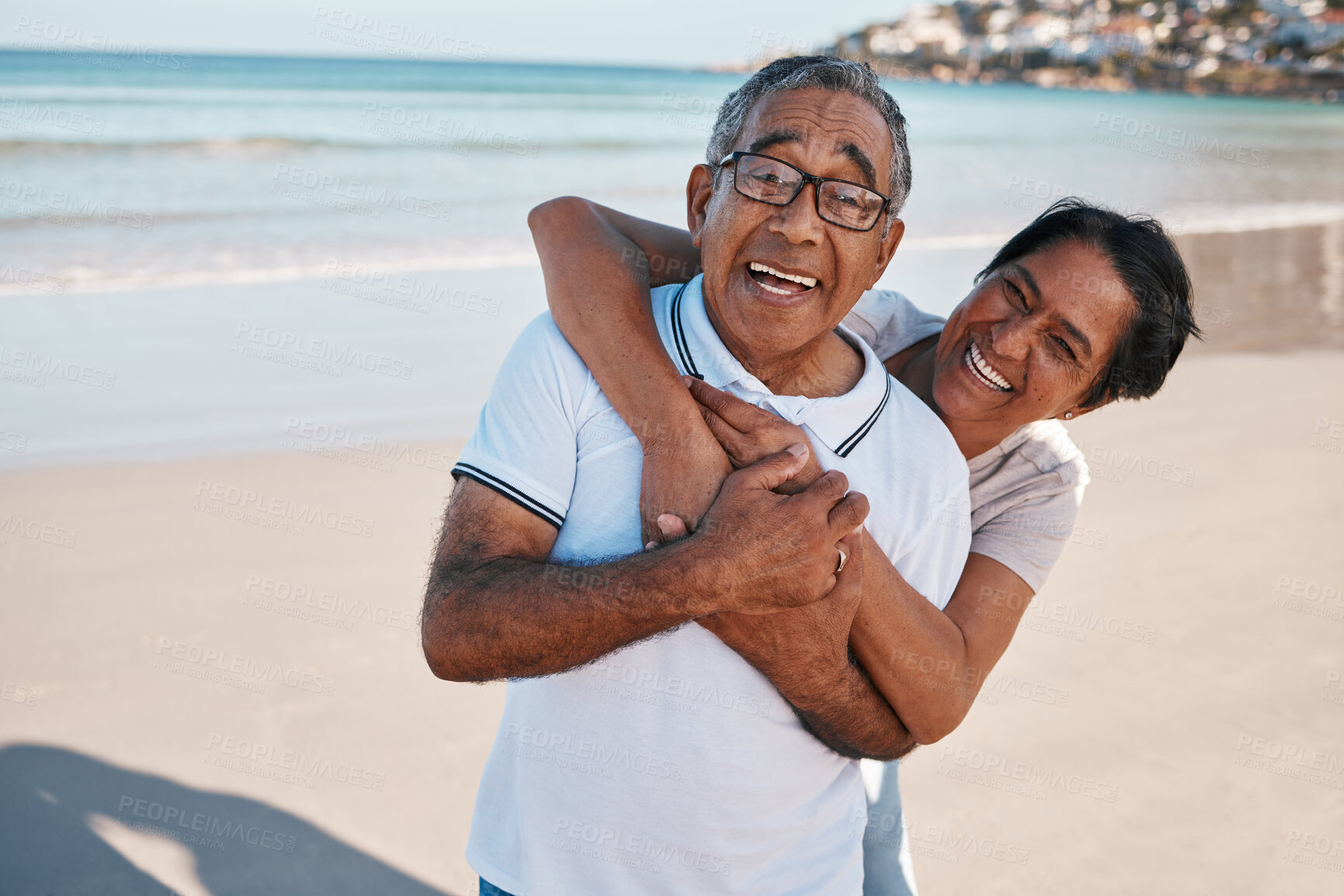 Buy stock photo Outdoor, portrait and senior couple at beach with hug for happiness, laughing or summer getaway trip. Ocean, married woman and elderly man with embrace for love, vacation or holiday in Bahamas