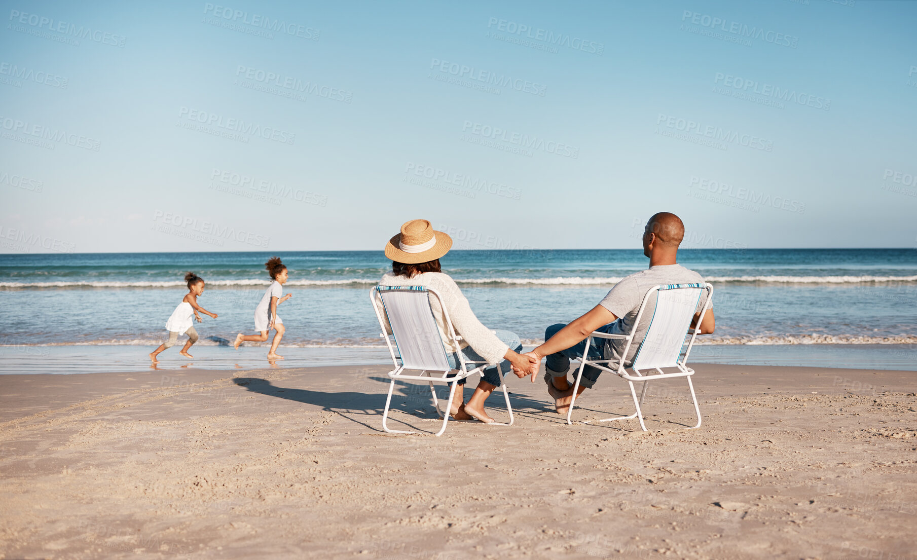 Buy stock photo Playing, children and parents in chair on beach for holiday adventure together on tropical island. Family, man and woman on ocean vacation with playful kids in waves on travel to Indonesia from back