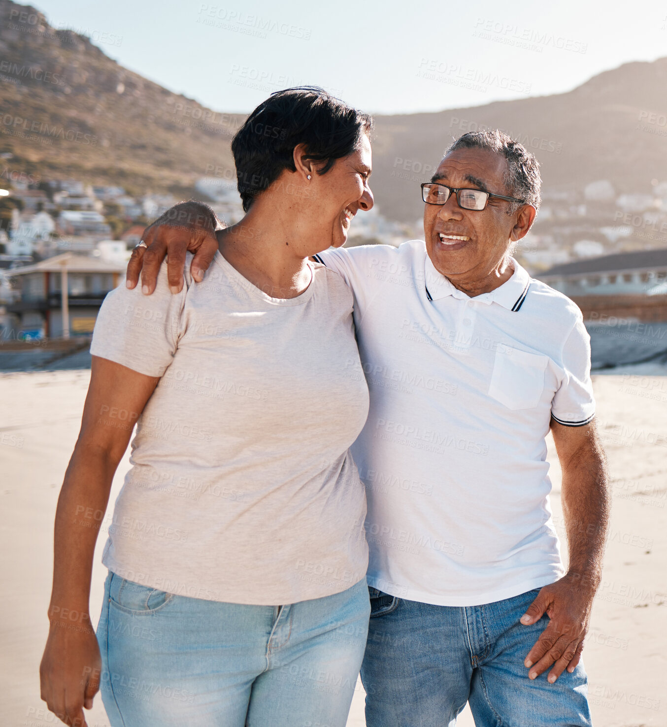 Buy stock photo Outdoor, walking and senior couple on beach with hug for happiness, talking or summer getaway trip. Ocean, married woman and elderly man with smile for conversation, vacation or holiday in Bahamas