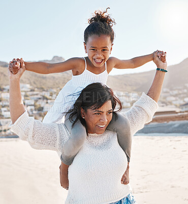 Buy stock photo Shot of a little girl and her mother spending time at the beach
