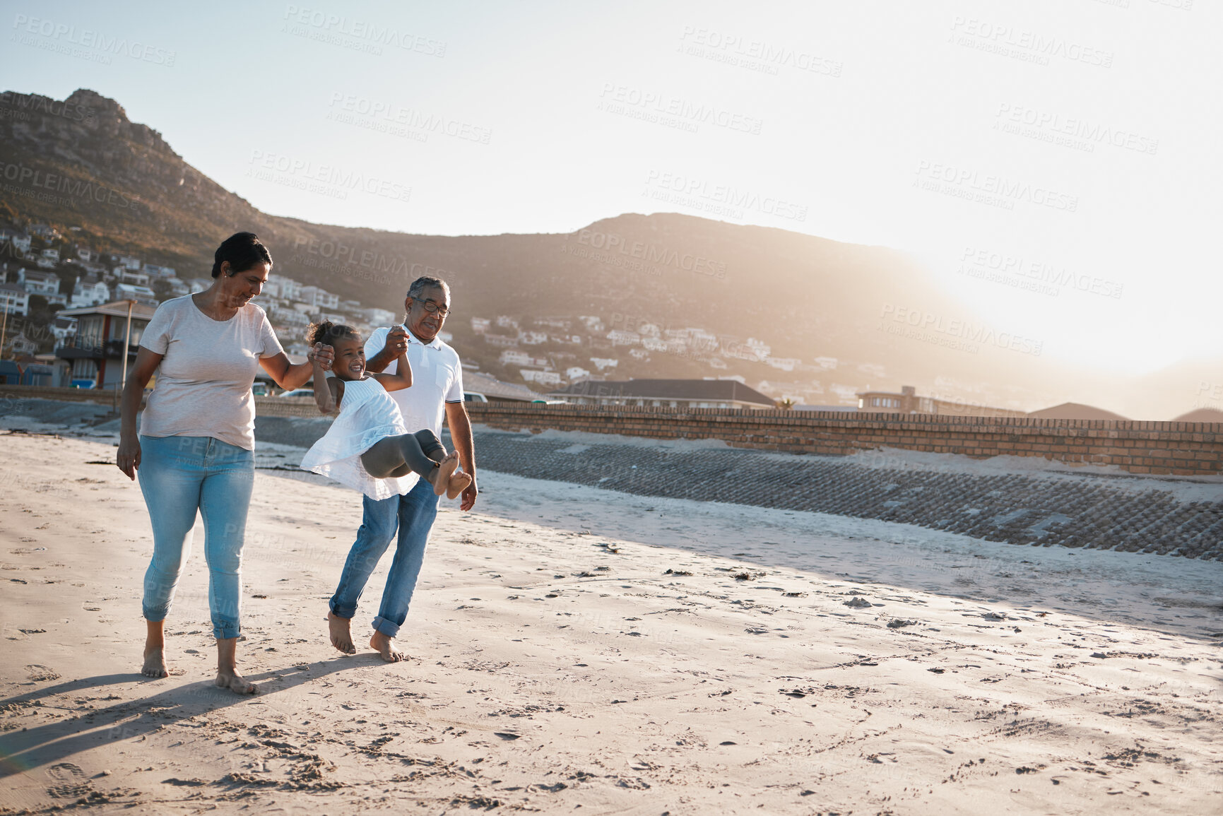 Buy stock photo Beach, grandparents and child holding hands, playing and bonding on outdoor holiday adventure in Mexico. Ocean, sunset and happy family walking with man, woman and girl on summer vacation together