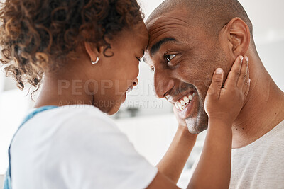 Buy stock photo Shot of a young father and daughter spending time together at home