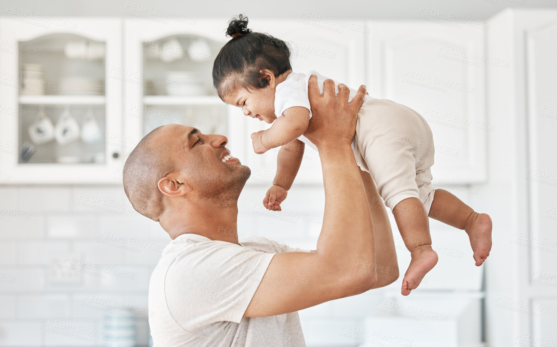 Buy stock photo Dad, happy and lifting baby with love for bonding together, security and healthy growth in family home. Father, smile and holding newborn girl for care, safety and support for development in kitchen