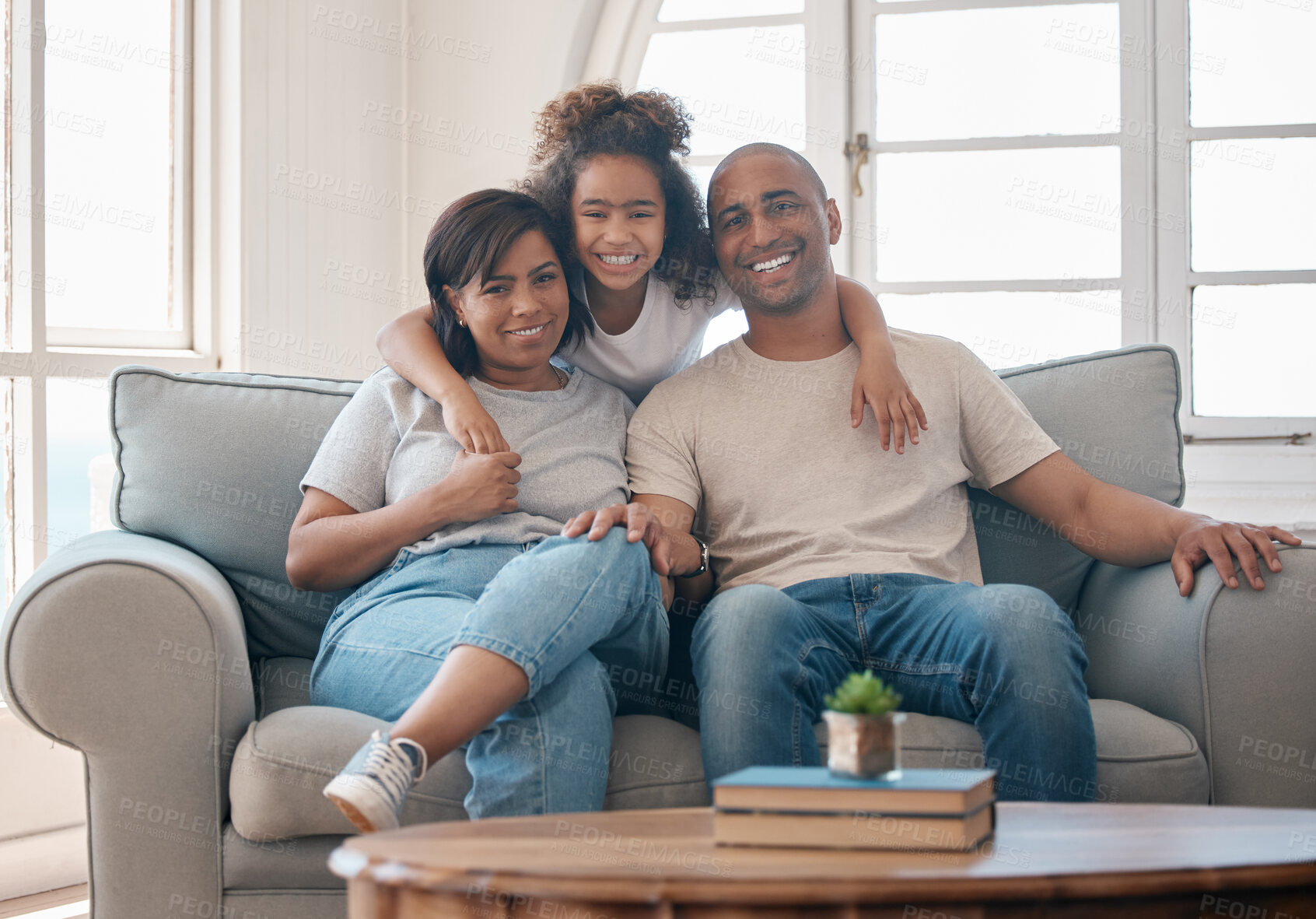 Buy stock photo Shot of a young family relaxing together at home