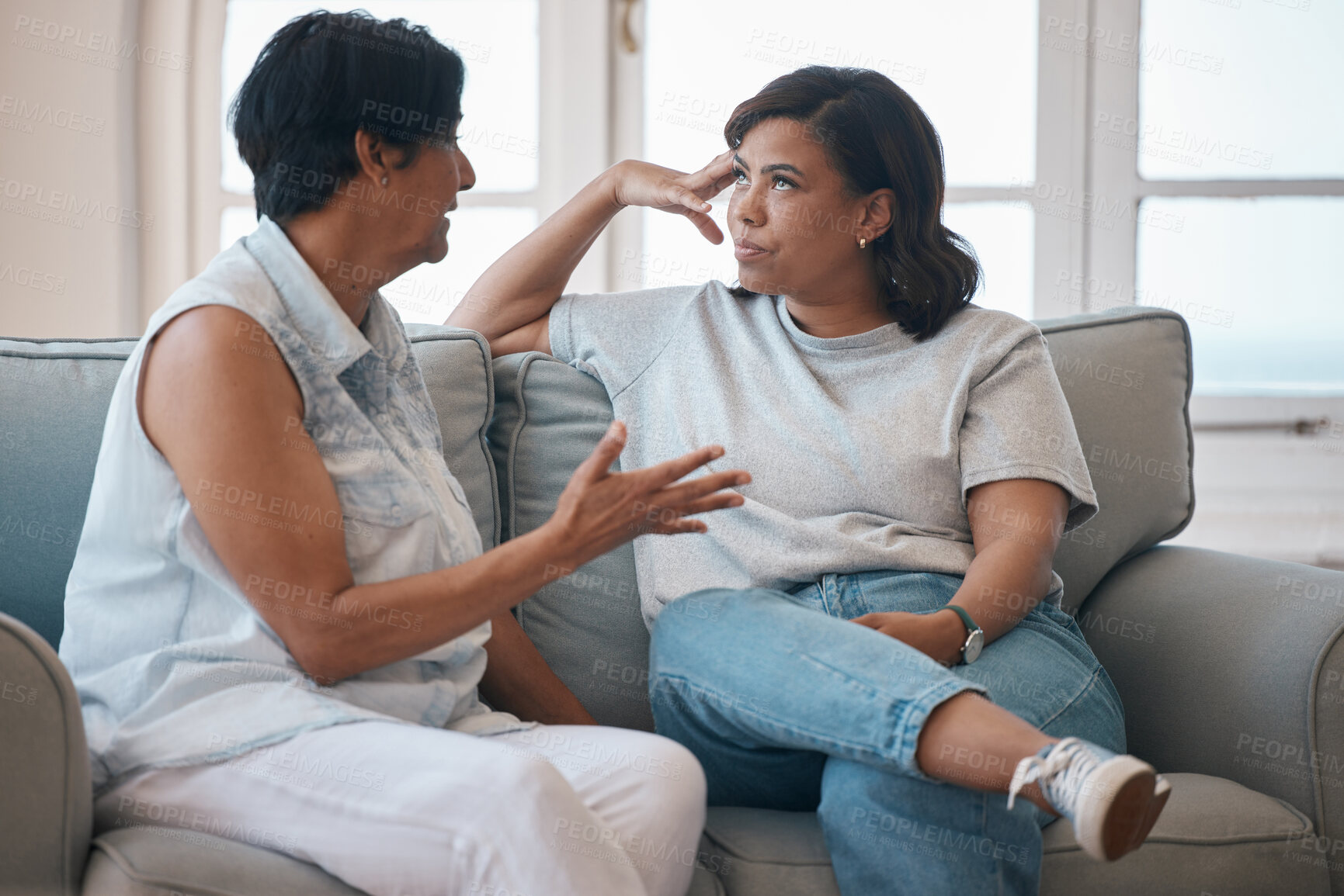 Buy stock photo Mother, daughter and sofa or argument with conversation for advice, support with lecture for problem. Mom, woman and together in home with communication for mistake, frustrated or angry for fail