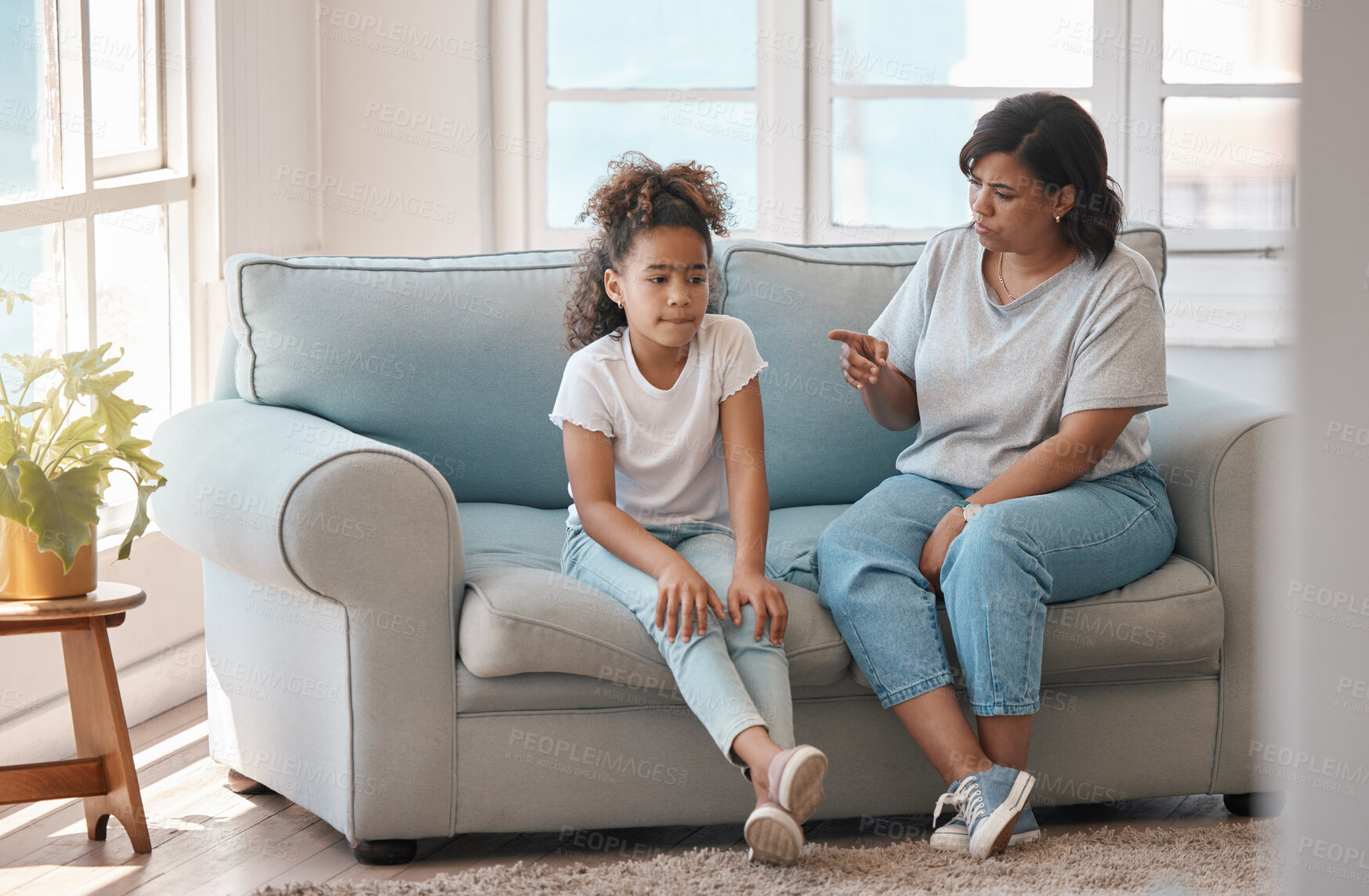 Buy stock photo Discipline, mom and girl on sofa for bad behavior, conflict and teaching in living room. Mother, daughter and lecture at home for mistake, punishment and advice for development with strict parenting