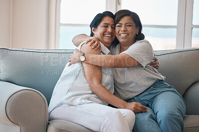 Buy stock photo Shot of a young woman hugging her mother