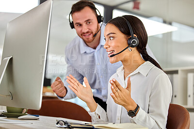 Buy stock photo Shot of two coworkers working together in a call center