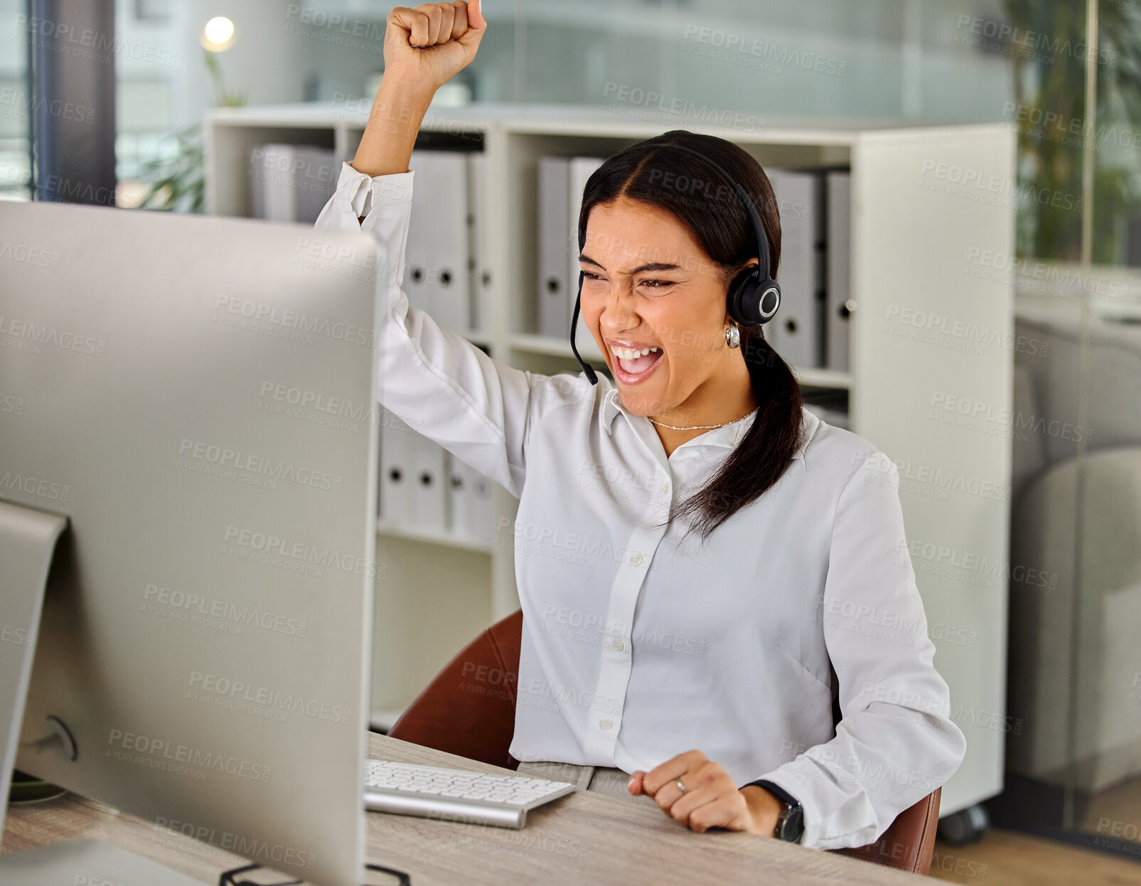 Buy stock photo Shot of a young businesswoman cheering while working in a call center