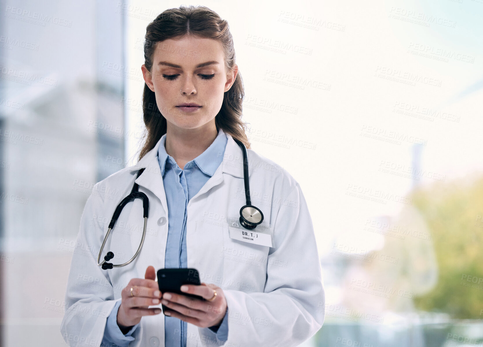 Buy stock photo Phone, woman or doctor in hospital on social media to search for medicine info or research online. Scroll, mockup or medical healthcare professional browsing on mobile app to chat in clinic 