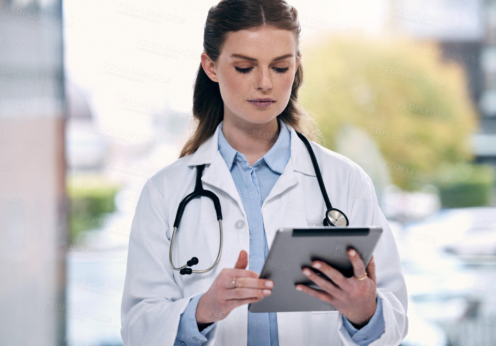 Buy stock photo Tablet, woman or doctor in hospital with research to search for medicine web info on social media. Telehealth, scroll or medical healthcare professional reading or browsing on app to chat in clinic 