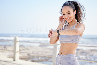 Buy stock photo Time, check and woman with earphones, outdoor and listen to music, streaming and smile for exercise. Nature, runner and athlete with watch, happy and ready for training, radio or podcast for workout