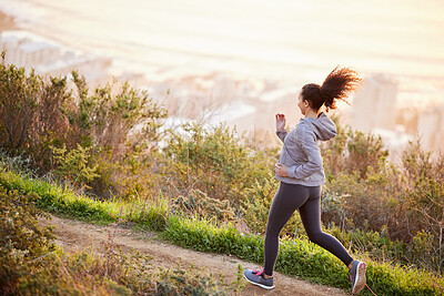 Buy stock photo Shot of a beautiful young woman enjoying her morning run outside