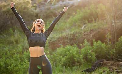 Buy stock photo Shot of a young woman celebrating her progress while out on her morning run outside