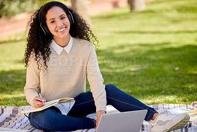 Buy stock photo Portrait of happy woman in park studying with headphones, laptop and notes for education in nature, learning and music. Smile, research and university student on grass with audio books for project.