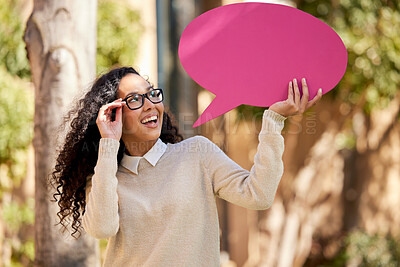 Buy stock photo Shot of a beautiful young student holding a speech bubble above her head while standing outside