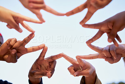 Buy stock photo Shot of a group of unrecognizable students joining hands in a star shape while standing outside