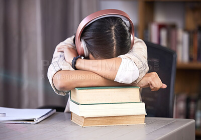 Buy stock photo Headphones, books and girl with sleeping in library for studying, burnout and knowledge for exam. University, student and tired with rest on table for scholarship, education or deadline of assignment