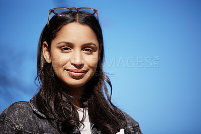 Buy stock photo Portrait, outdoor and girl with glasses, student and education with university, sunshine and blue sky. Face, college or person with eyewear, gen z and stylish clothes with confidence or trendy outfit