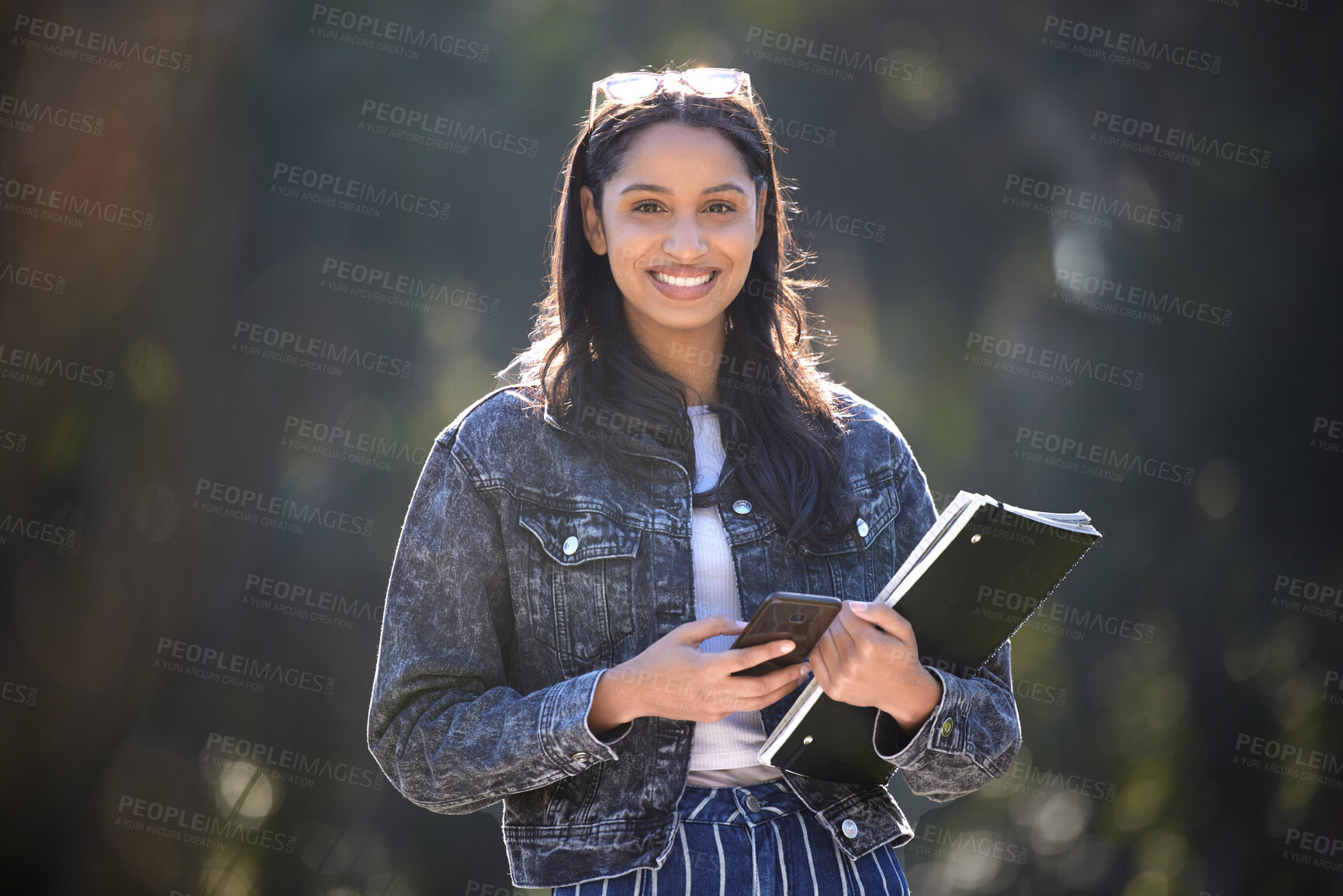 Buy stock photo Happy, woman or student in nature with smartphone and books for commute to college campus. Smile, female person and mobile walking with notebook for travel, learning and university education