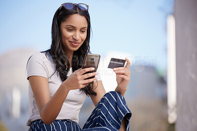 Buy stock photo Shot of a beautiful young student using her phone while sitting outside