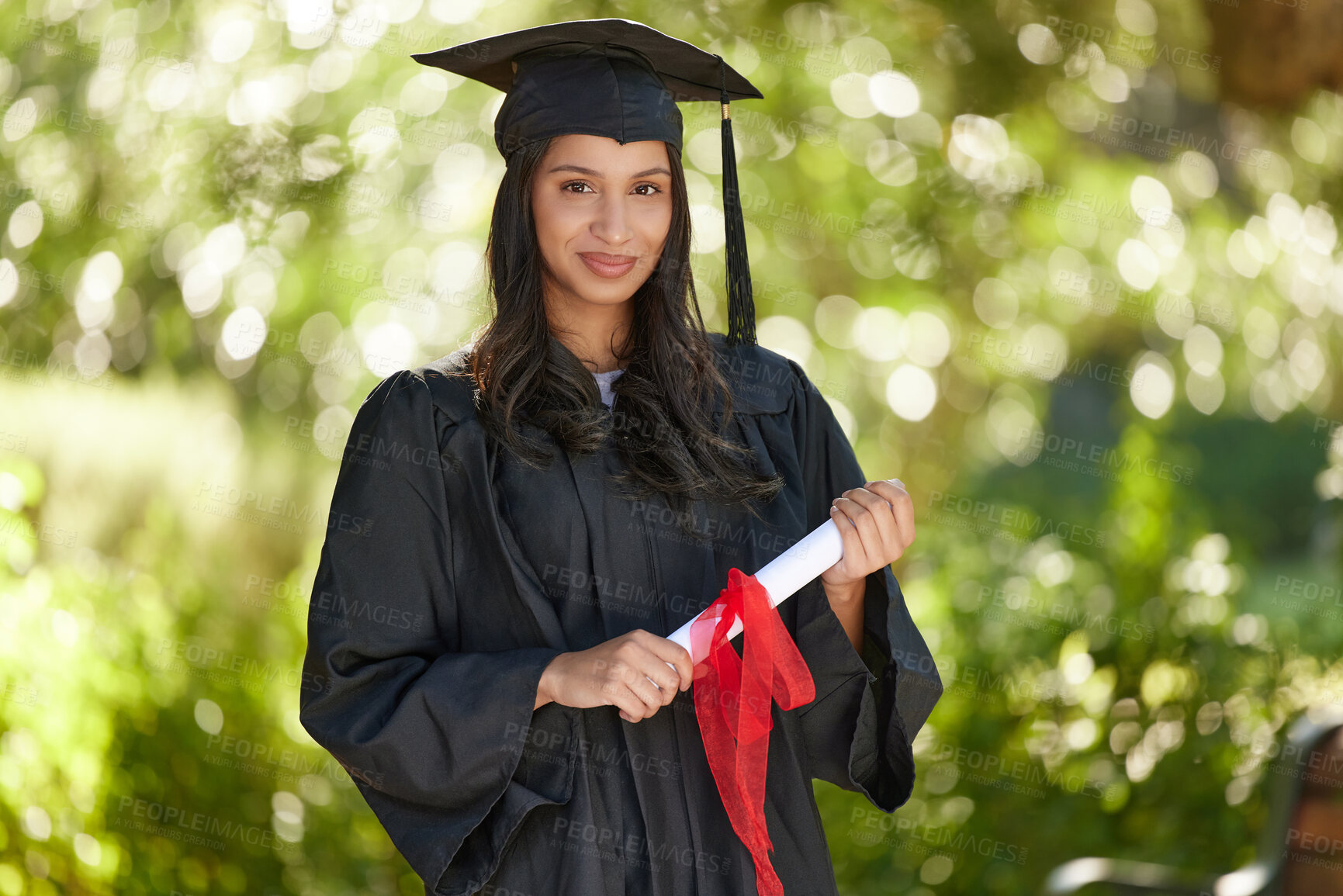 Buy stock photo Portrait of a young woman holding her diploma on graduation day