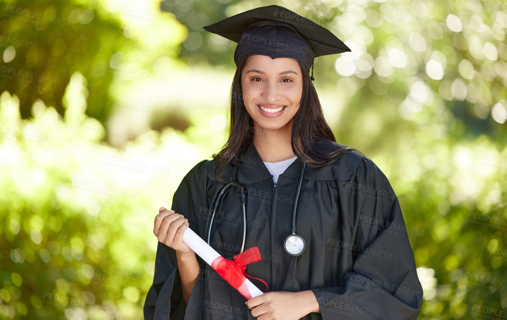 Buy stock photo Portrait of a young woman holding her diploma on graduation day