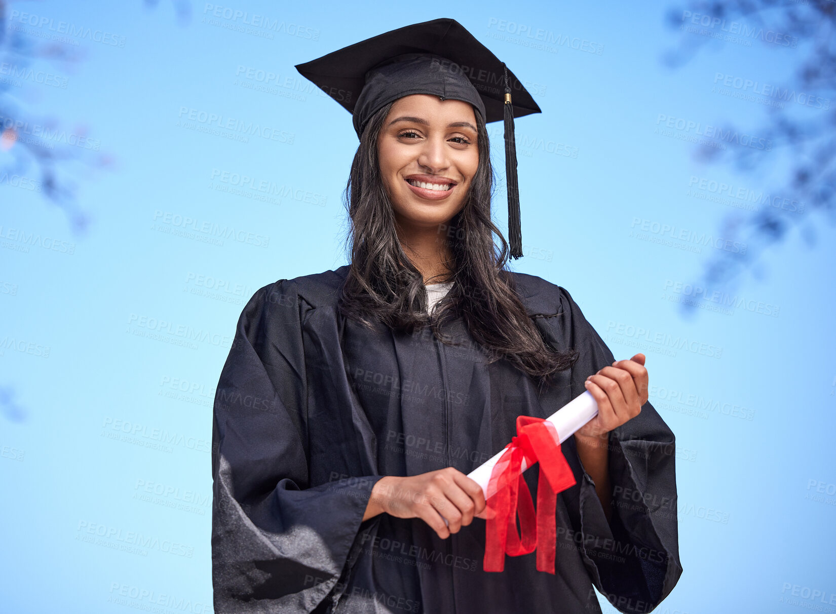 Buy stock photo Portrait of a young woman holding her diploma on graduation day