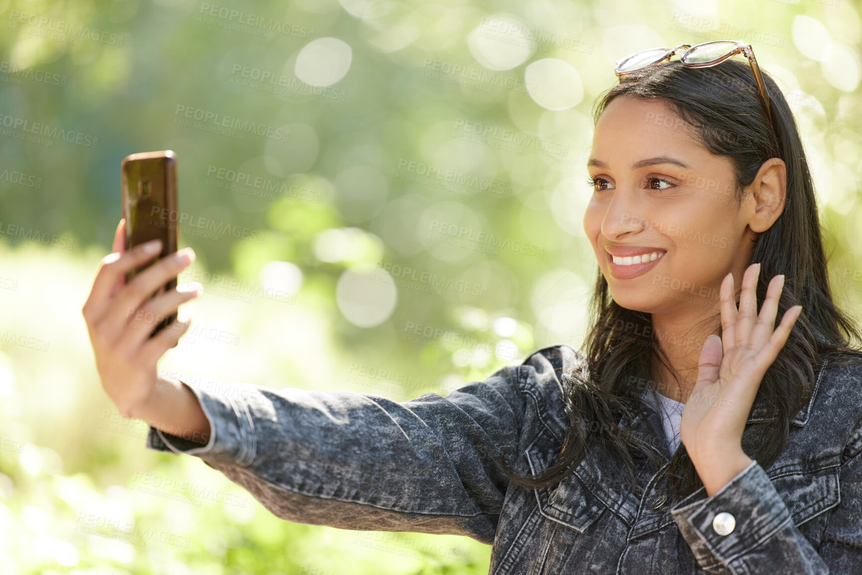 Buy stock photo Young woman, video call and smile outdoor in park for social media, internet sharing and memories. Happy, female person or student in nature with technology for communication, contact and online post