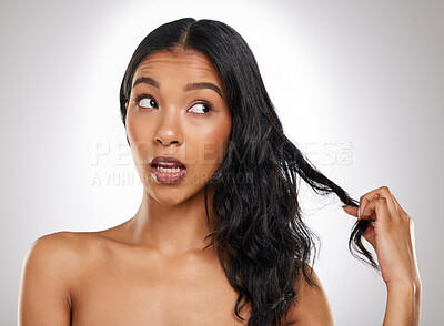 Buy stock photo Hair damage, woman and thinking in studio for haircare, attitude and edgy on gray background. Female person, repair and salon treatment for wellness, remedy and growth for results and beauty