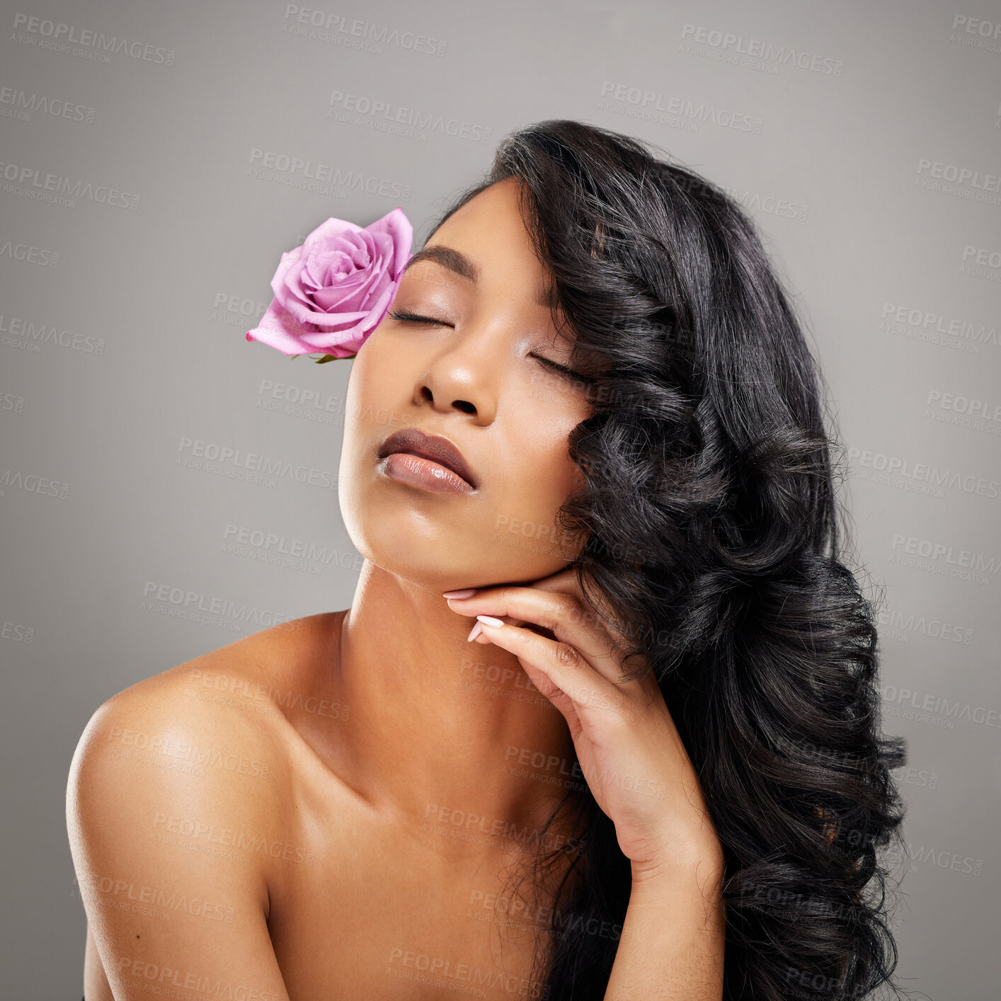 Buy stock photo Hair care, flower and woman in studio with wellness, health and salon treatment for confidence. Cosmetic, beauty and person from Mexico with curls hairstyle and purple floral plant by gray background