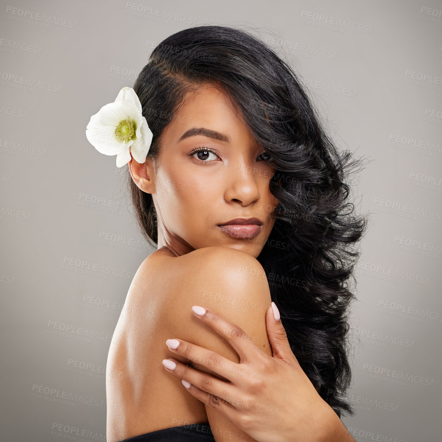 Buy stock photo Hair care, beauty and woman with lily in studio with beauty, health and salon treatment for confidence. Portrait, wellness and person from Mexico with curls hairstyle and flower by gray background.