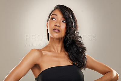 Buy stock photo Shot of a beautiful young woman posing against a grey background