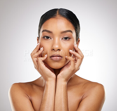 Buy stock photo Skincare, shine and woman with hands on face in studio for wellness, dermatology and treatment on grey background. Natural beauty, portrait and girl model touch skin, cosmetics or cleaning results