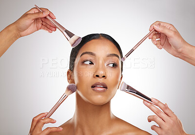 Buy stock photo Studio shot of an attractive young woman having her makeup done backstage against a grey background