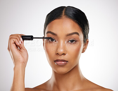 Buy stock photo Makeup, product and portrait of woman with mascara in studio background and application of cosmetics. Face, beauty and model with luxury wand tool for aesthetic volume in lashes and skincare