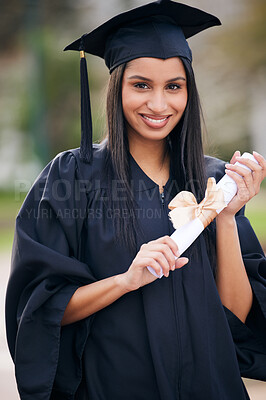 Buy stock photo Portrait of a young woman holding her diploma on graduation day