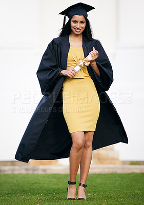 Buy stock photo Portrait of a young woman holding her diploma on graduation day