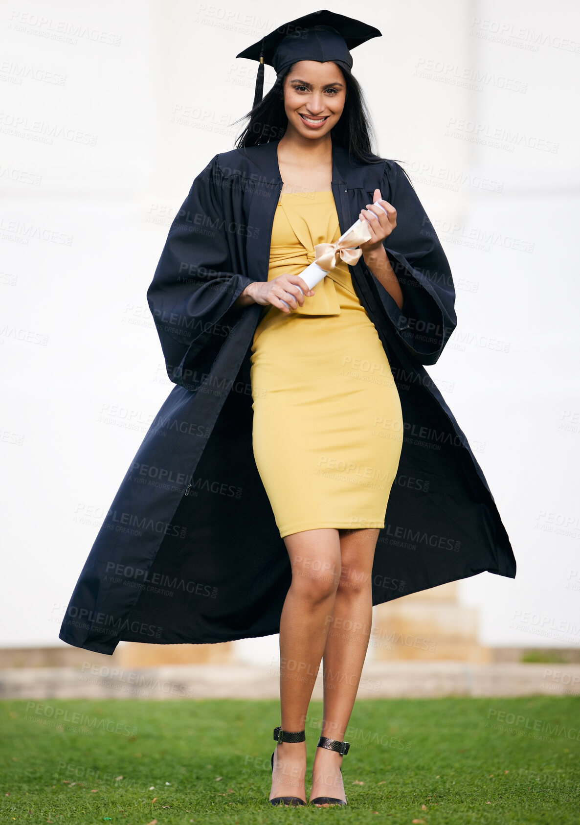 Buy stock photo Portrait of a young woman holding her diploma on graduation day