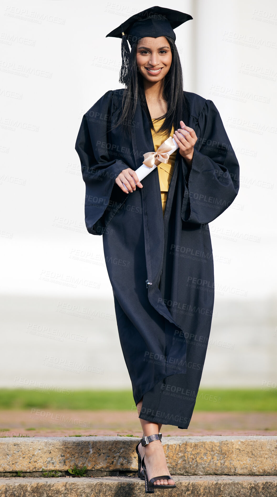 Buy stock photo Portrait of a young woman holding her diploma on graduation day