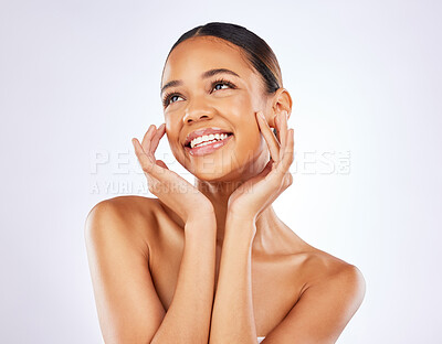 Buy stock photo Shot of a happy young woman posing against a studio background