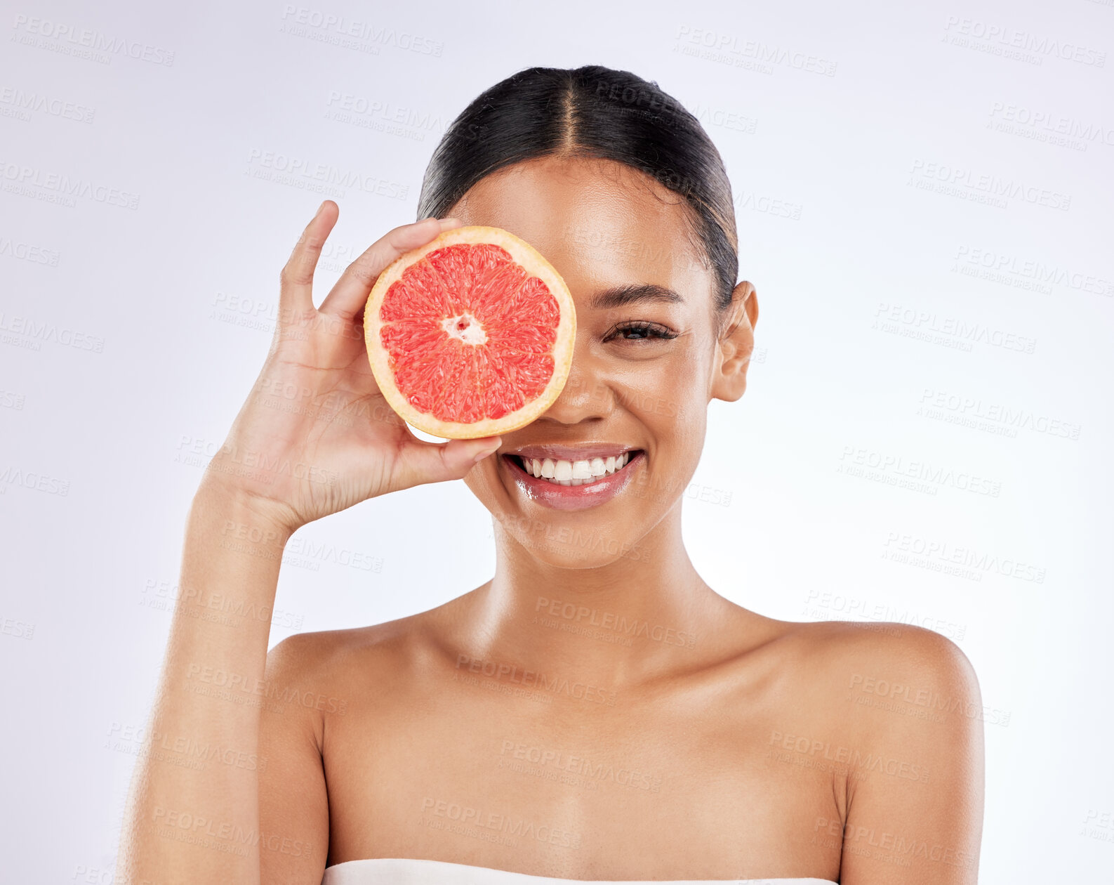 Buy stock photo Woman, happy and grapefruit for skincare in studio on white background and satisfied with routine. Natural, beauty and smile with confidence on portrait for skin treatment, ingredient and glow