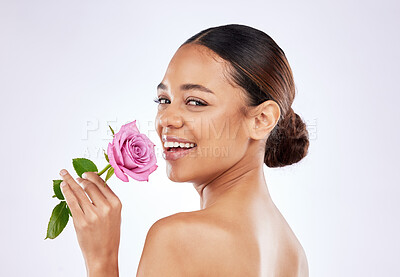 Buy stock photo Rose, flower and portrait of happy woman with skincare or healthy dermatology on studio background. Floral, cosmetics and girl with natural glow on face or scent of blossom with beauty in spring